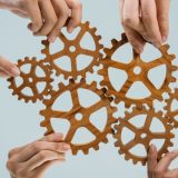 Business team joining cogwheel