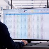 man looking at spreadsheet